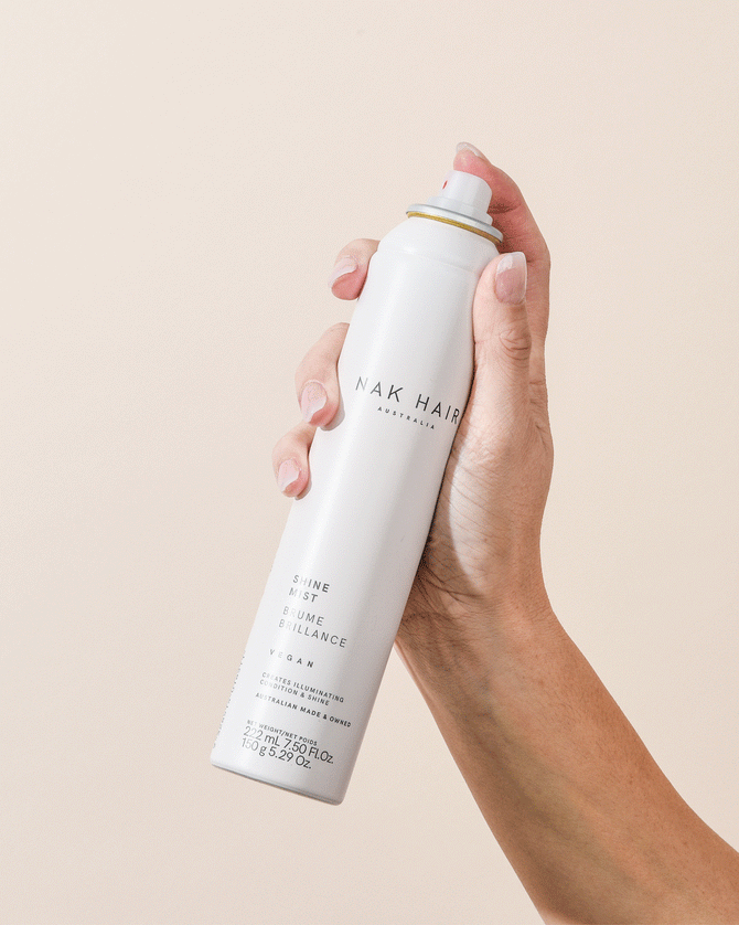 Image of NAK Shine Mist 150g in use spraying a conditioning mist designed to deliver radiant shine