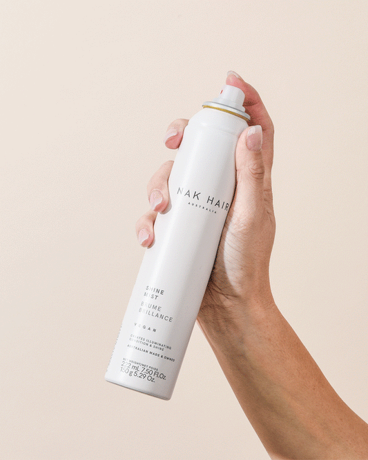 Image of NAK Shine Mist 150g in use spraying a conditioning mist designed to deliver radiant shine