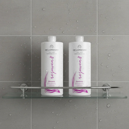 Two bottles of De Lorenzo Rejuven8 shampoo and conditioner on a shower shelf