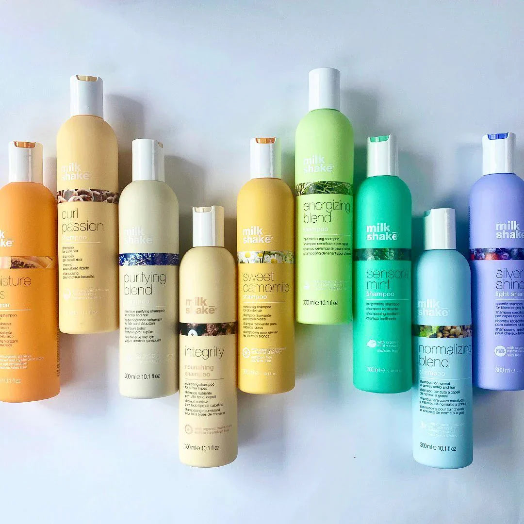 A collection of milk_shake haircare products, featuring shampoos, conditioners, and styling treatments with vibrant packaging. Formulated with nourishing ingredients, these products enhance hydration, shine, and colour protection