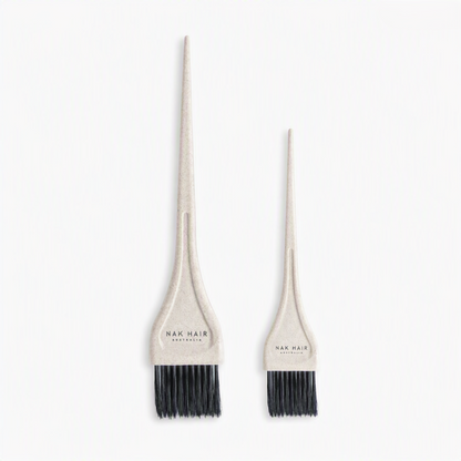 Two beige hair dye applicator brushes with black bristles, one large and one small, both branded 'NAK HAIR AUSTRALIA' on the handles, set against a plain white background.