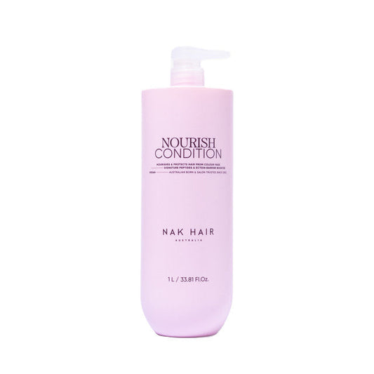 Pink bottle of NAK Hair Nourish Condition on a white background