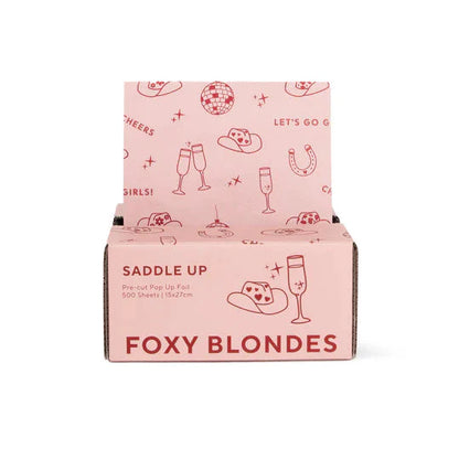 Pink packaging box with 'Foxy Blondes' branding and graphics on a white background
