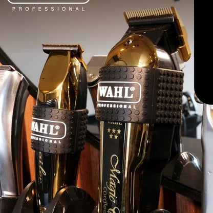 Gold Wahl professional hair trimmer in a holder with visible branding with clipper grips