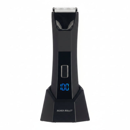 A black electric hair trimmer with a digital display showing '100' in blue, labeled 'SILVER BULLET' on the base, shown against a split white and dark textured background.