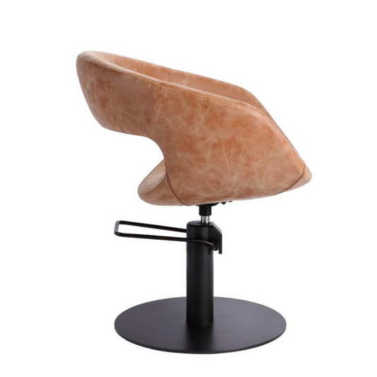 Brown leather salon 
chair with black metal base on a white background