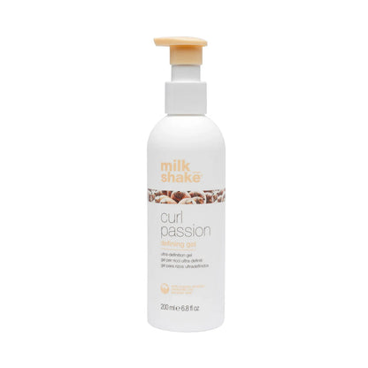 Bottle of Milk Shake Curl Passion defiing gel product on a white background
