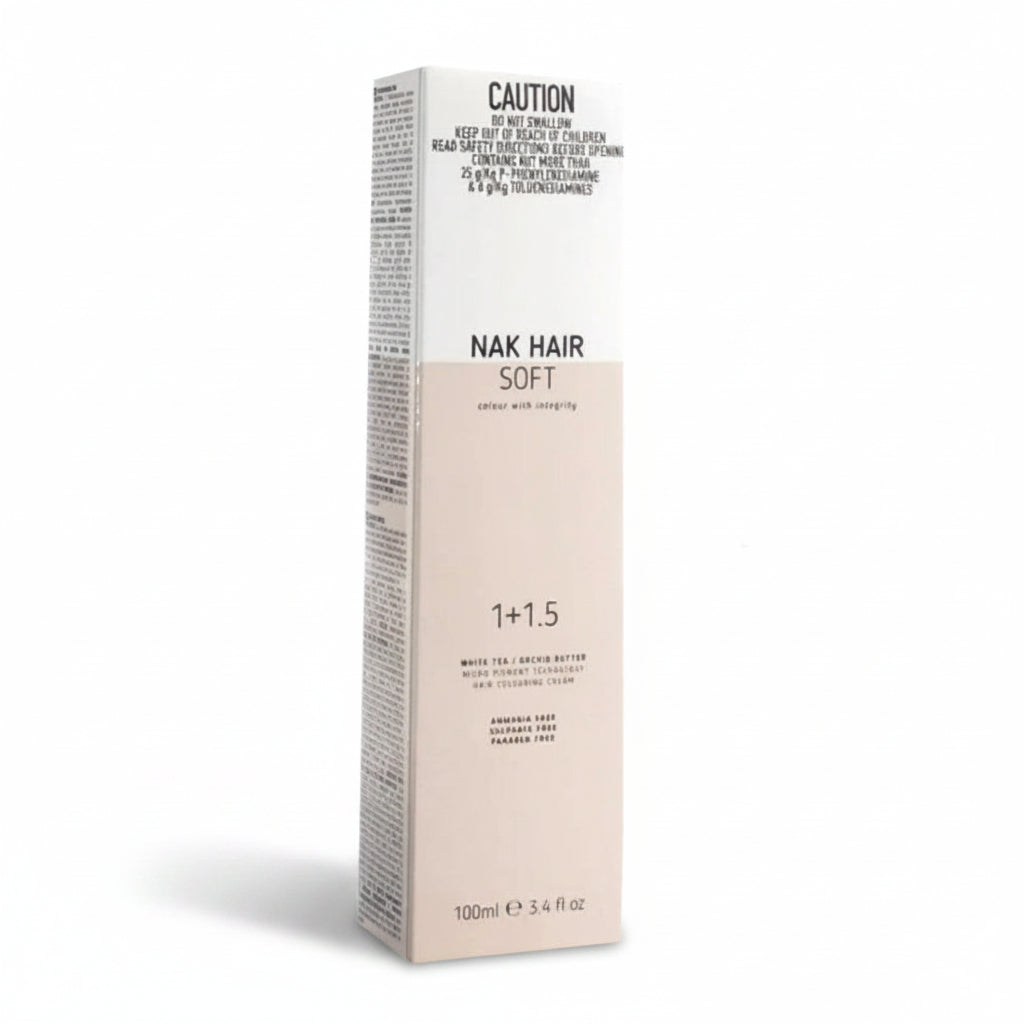 A tall rectangular box of NAK HAIR Soft 1+1.5 cream hair color, featuring a white top half and a pale peach-beige bottom half, on a plain white background.