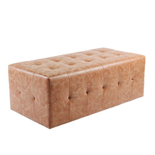 Brown leather ottoman for salon waiting room or reception area with tufted design on a white background