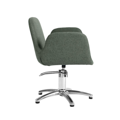 A modern upholstered salon chair with a dark green fabric seat and back, supported by a chrome five-star base on a white background.
