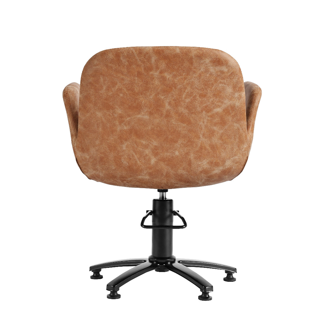 A modern swivel salon hairdressers chair with a rounded, cushioned backrest upholstered in a textured tan leather or faux leather material, supported by a black five-star swivel base.